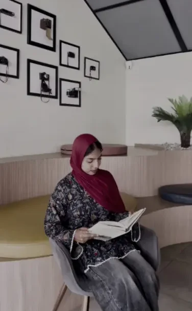 a freelance digital marketaing consultant in qatar reading in a modern indoor space